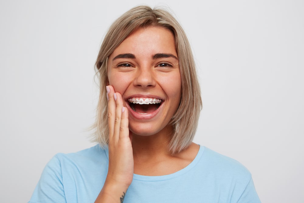 Happy young woman with braces
