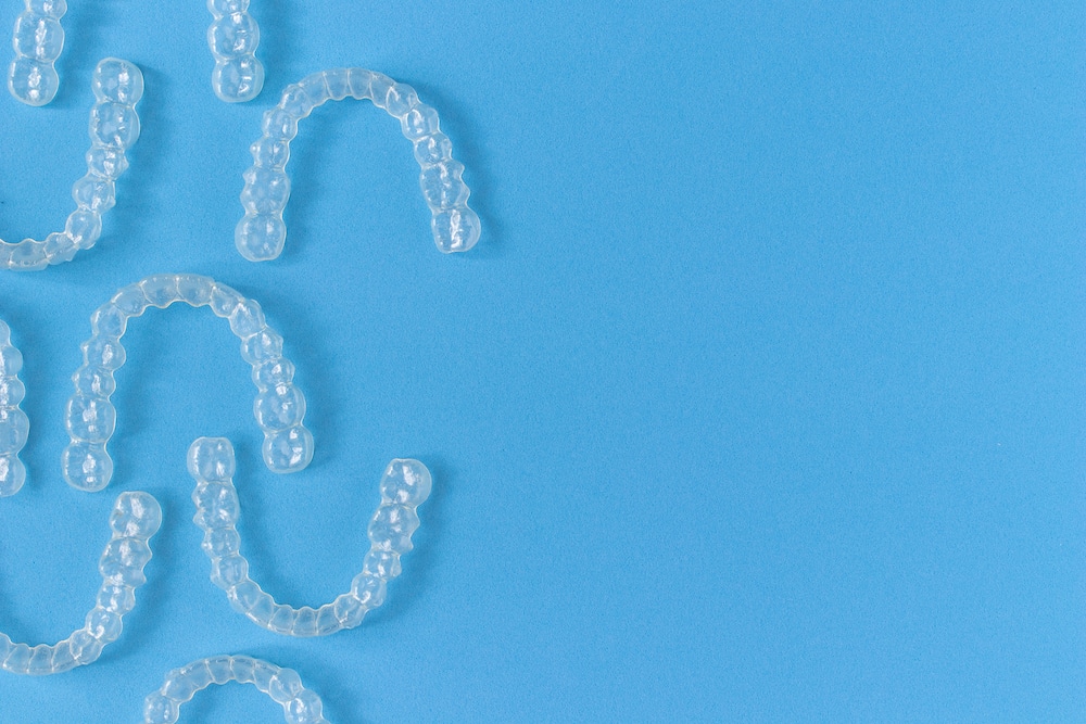 Clear teeth aligners on blue background