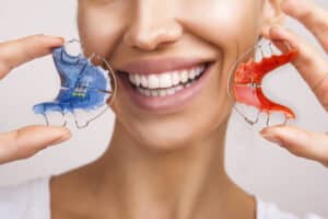 Dental,And,Ortho, ,Beautiful,Smiling,Girl,Holding,Retainer,For