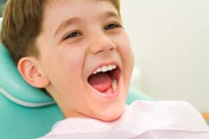 Photo,Of,Youngster,With,His,Mouth,Wide,Open,During,Checkup