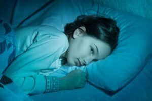 A child with sleep apnea lying in bed