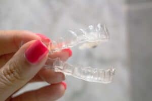 A close-up shot of a removable retainer in Denver, CO
