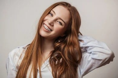 happy-young-redhaired-woman-braces-260nw-1089826847 happy young redhaired woman braces 260nw 1089826847 Ceramic Braces in Denver, CO